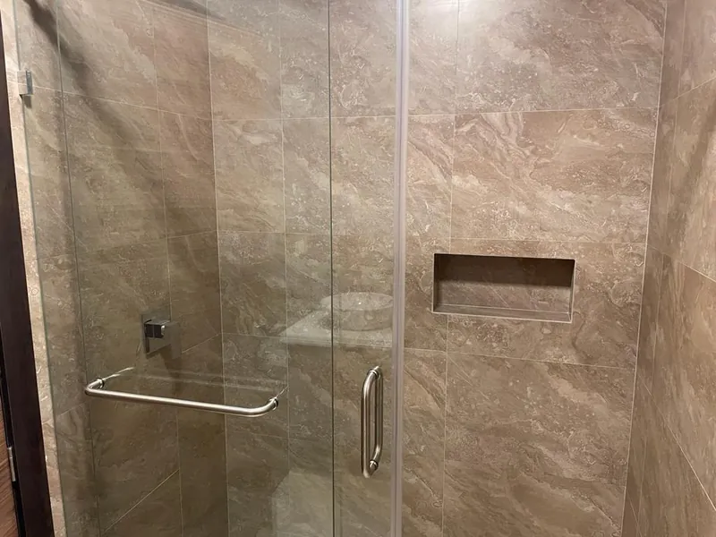 Tiled shower with frameless glass door