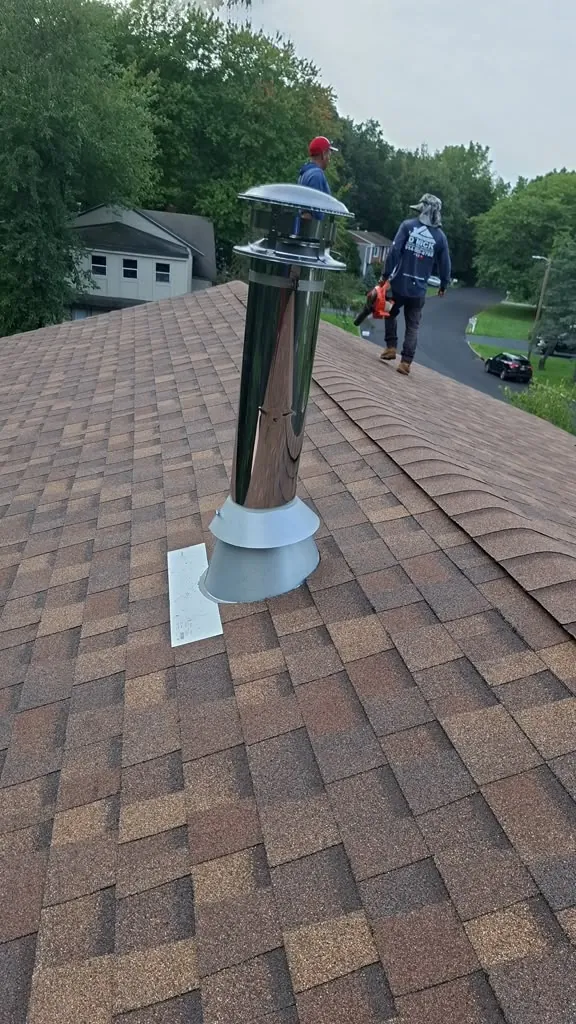 New shingle roof with chimney pipe flashing